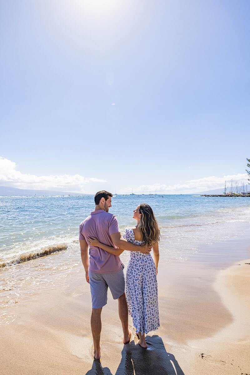 Couple embracing on beach.